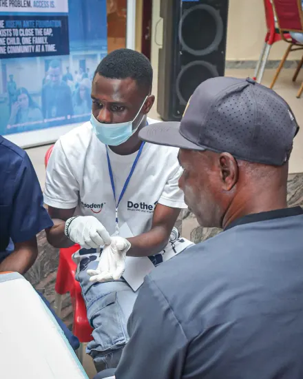A volunteer attends to a patient