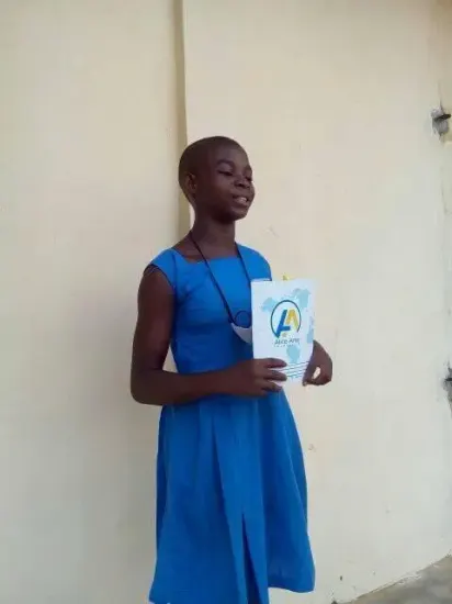 A pupil with her new notebook, One Child, One Pen, One Book 2023