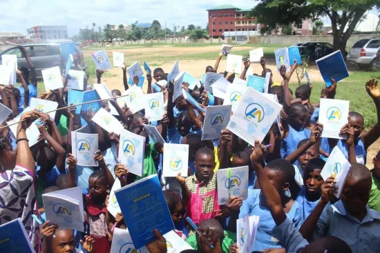 Students raise their new notebooks, One Child, One Pen, One Book 2023