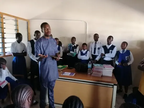 Speaker addressing students at a school outreach, The Gambia 2024