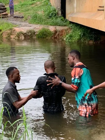 Baptism candidate supported by ministry leaders, Nigeria 2023