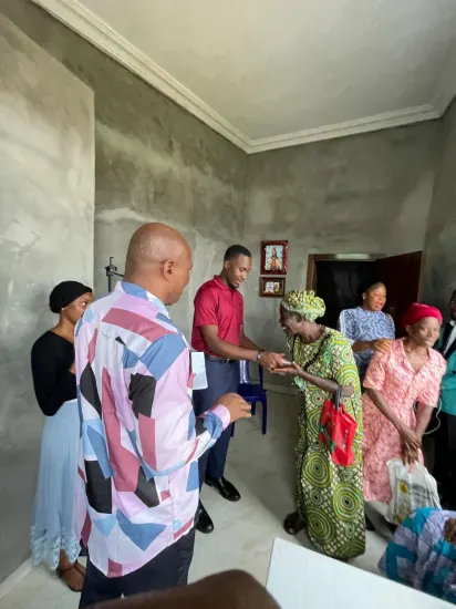 Pastor Joseph Ante with an older widow during a Widows Empowerment visit, Nigeria 2026